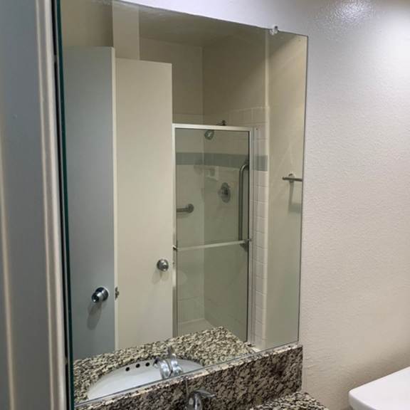 Thumbnail 5 of 30 A bathroom with a marble countertop and a white toilet.