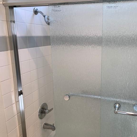 Thumbnail 3 of 30 A shower with a silver handle and a silver rod.