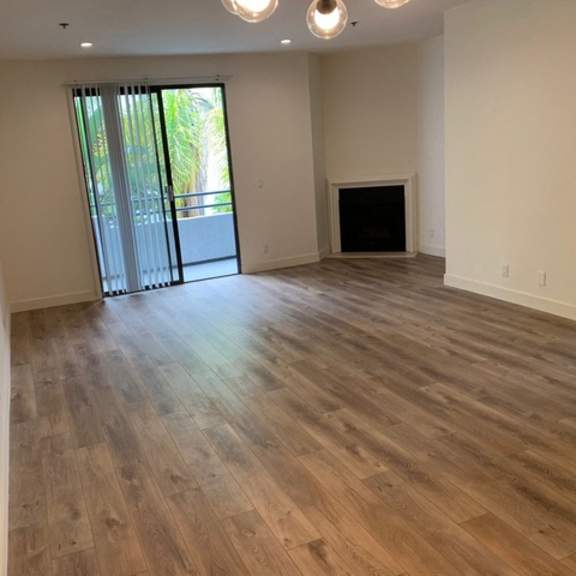 Thumbnail 19 of 27 A room with wooden flooring and a fireplace.