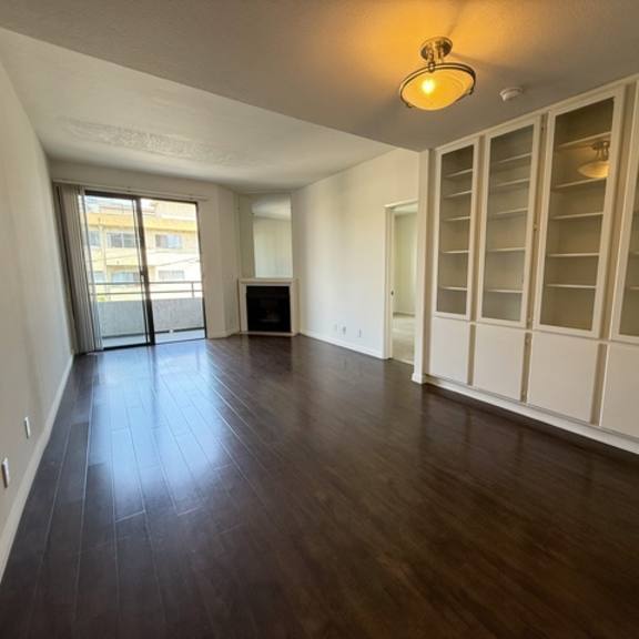 Thumbnail 12 of 44 A room with wooden floors and white walls.