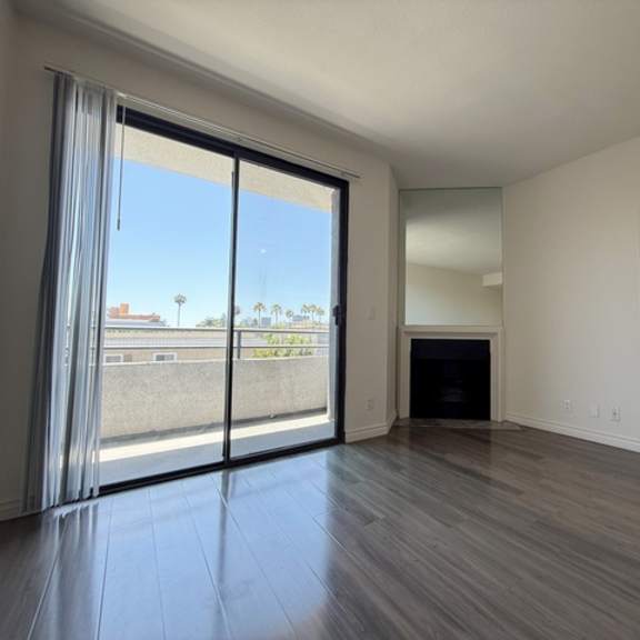 Thumbnail 9 of 54 A room with a fireplace and sliding glass doors.
