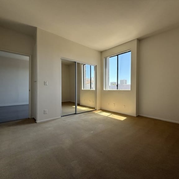 Thumbnail 39 of 54 A room with a carpeted floor and a window.