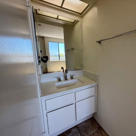 Thumbnail 31 of 54 A bathroom with a white sink and a white cabinet.