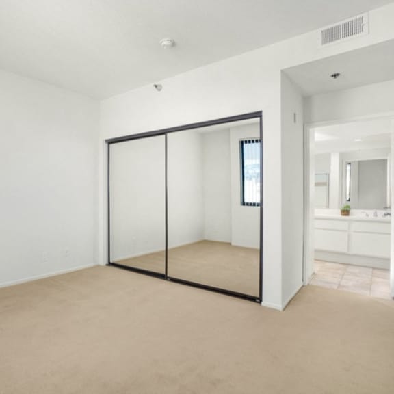Thumbnail 42 of 44 A room with a sliding door and carpeted floor.