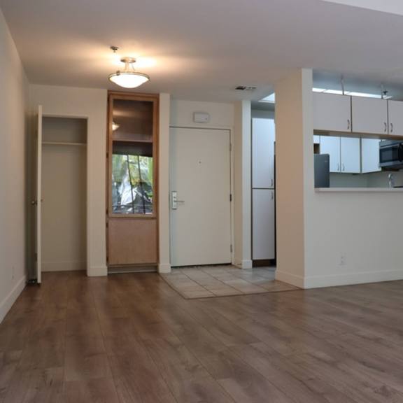 Thumbnail 18 of 30 A room with wooden floors and white walls.