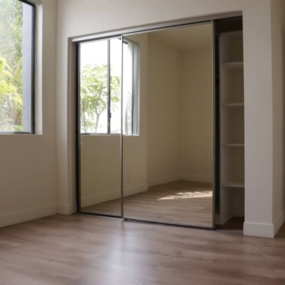 Thumbnail 22 of 30 A room with a sliding door and a window.