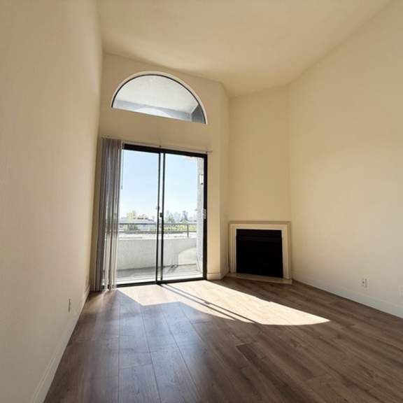 Thumbnail 19 of 19 A room with a fireplace and sliding glass doors.