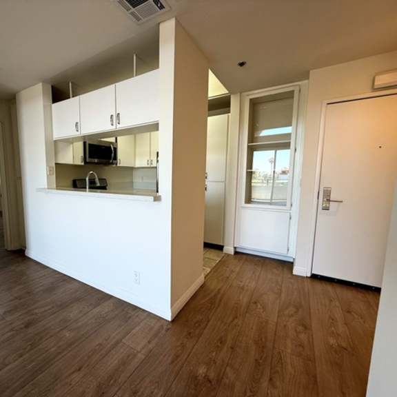 Thumbnail 24 of 54 A kitchen area with a microwave, oven, and cabinets.