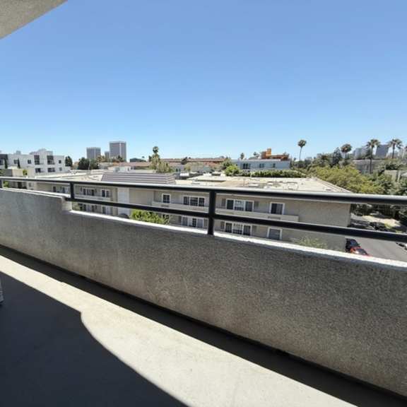 Thumbnail 42 of 54 A building with a balcony overlooking a cityscape.