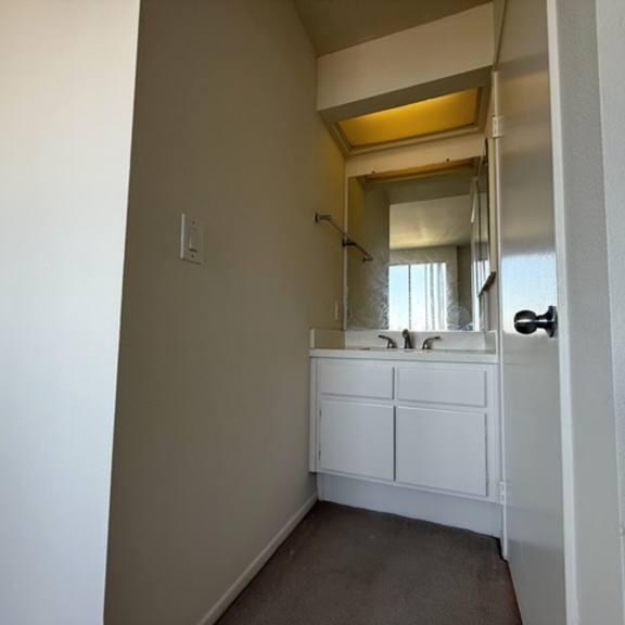 Thumbnail 12 of 22 A bathroom with a sink and a mirror.