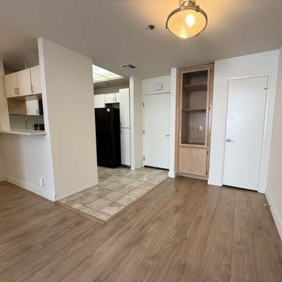 Thumbnail 5 of 19 A room with wooden floors and white walls.