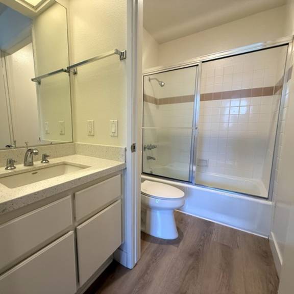 Thumbnail 22 of 26 A white toilet is in a bathroom with a walk-in shower.