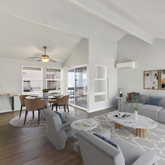 Thumbnail 2 of 18 A modern living room with a grey sofa, a coffee table, and a dining table set up.