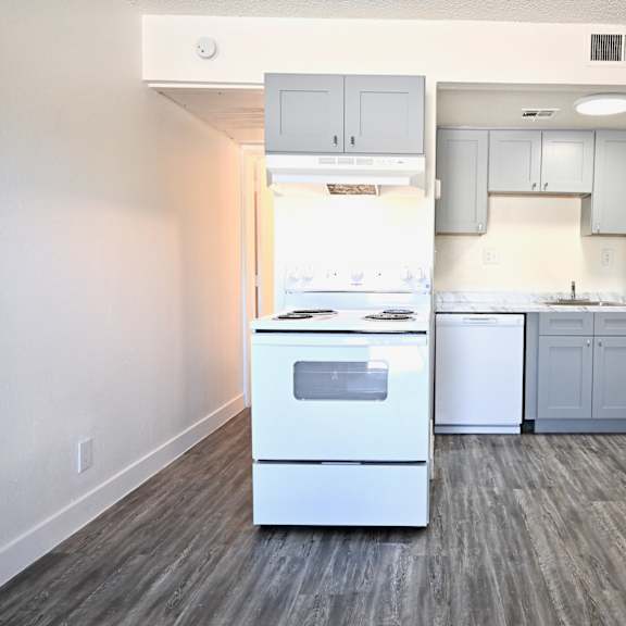 a kitchen with white appliances and cabinets.