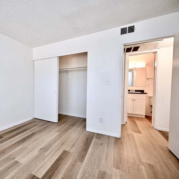 a room with a white wall and a wooden floor.