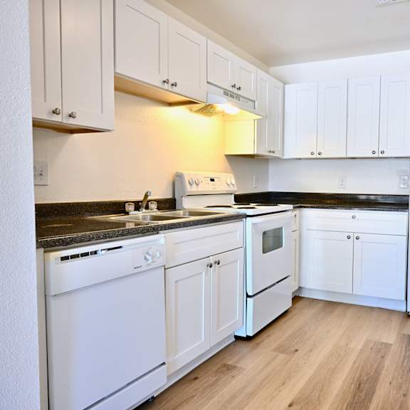a kitchen with white appliances and cabinets.