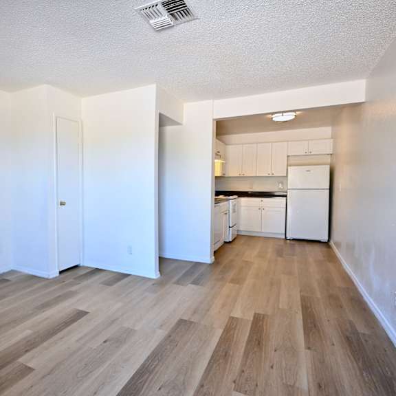 a room with wooden flooring and white walls.
