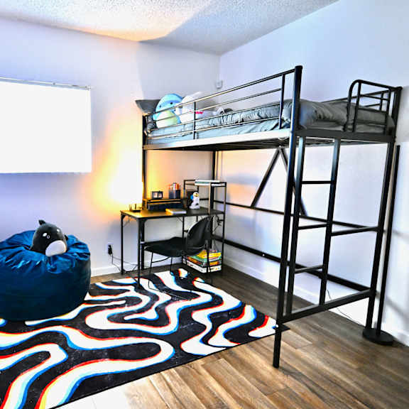 a room with a bunk bed and a bean bag chair.