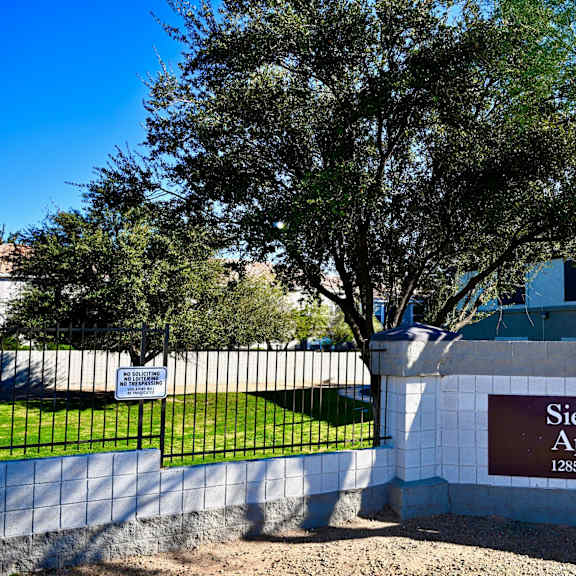 a sign for siesta pointe apartments is on a wall.