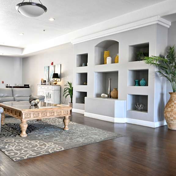 a living room with a grey couch and a coffee table.