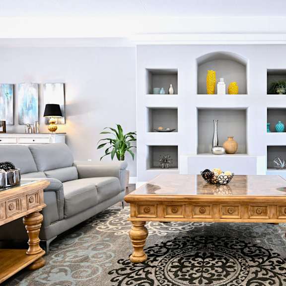 a living room with a wooden coffee table in the center.