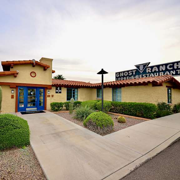 ghost ranch restaurant with blue doors and sign.