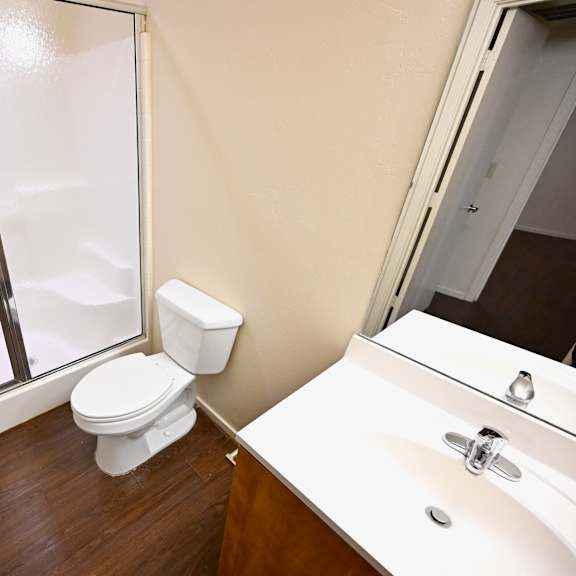 a white toilet sits next to a sink in a small bathroom.