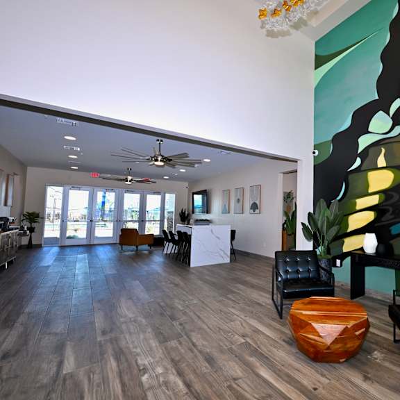 a large room with a butterfly mural on the wall and a wooden floor.