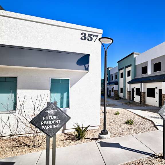 a sign in front of a building that says "future resident parking".