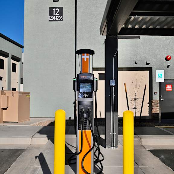 a parking meter is in front of a building with the number 12 on it.