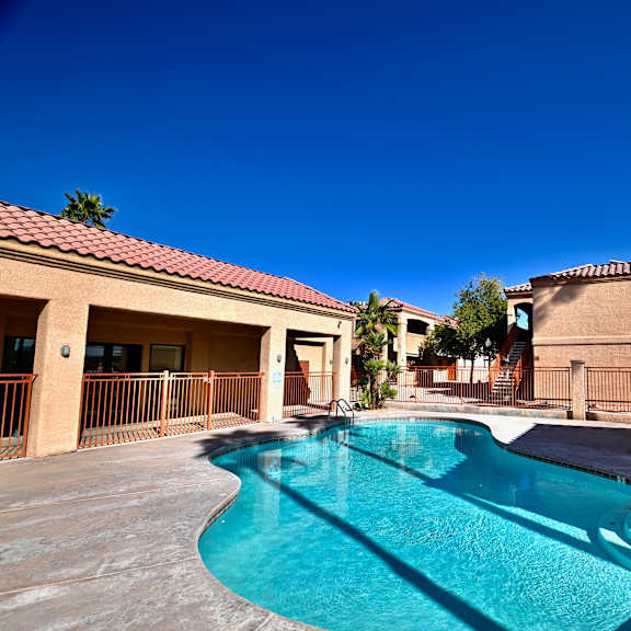 a swimming pool in a sunny backyard.
