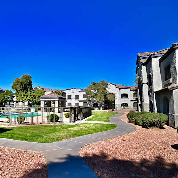 a sunny day at a residential complex with a clear blue sky.