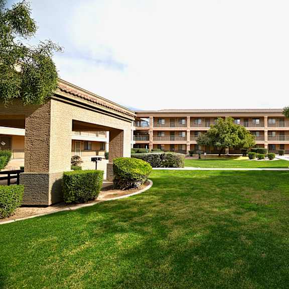 a grassy area in front of a building.
