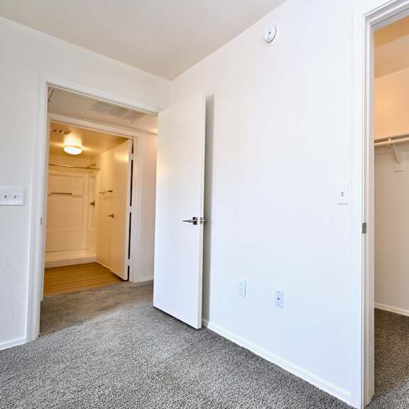 a white door is open to a hallway.