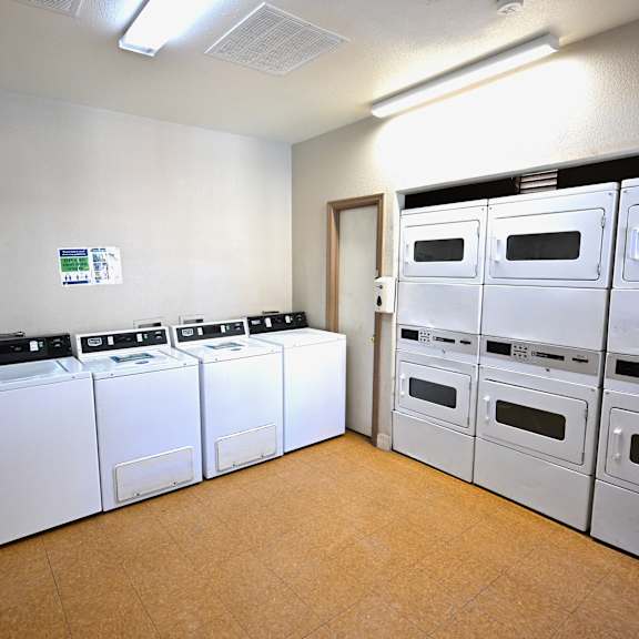 a row of white appliances are lined up in a room.