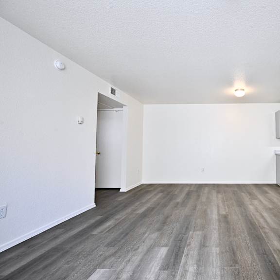 a room with a wooden floor and white walls.