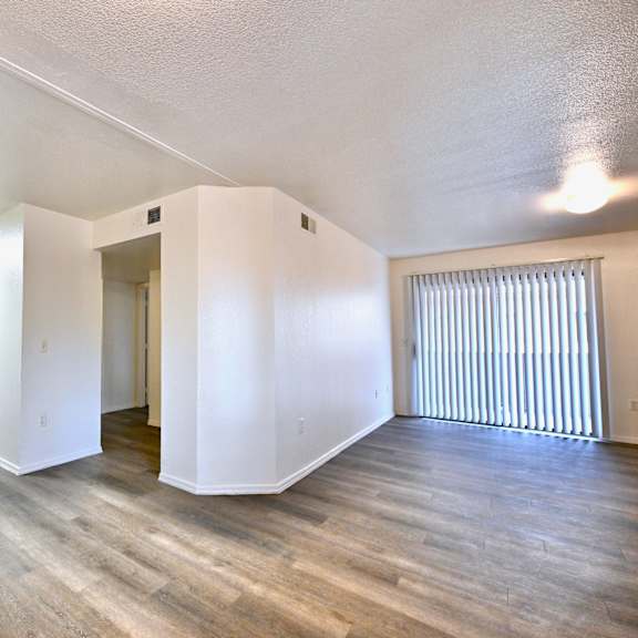 a kitchen with white cabinets and a wooden floor.