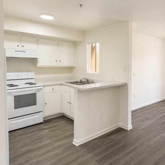a kitchen with white appliances and cabinets.