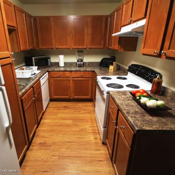 a kitchen with wooden cabinets and a black stove top.