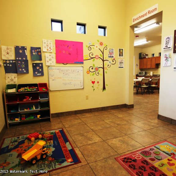 a classroom with a tree decoration on the wall.