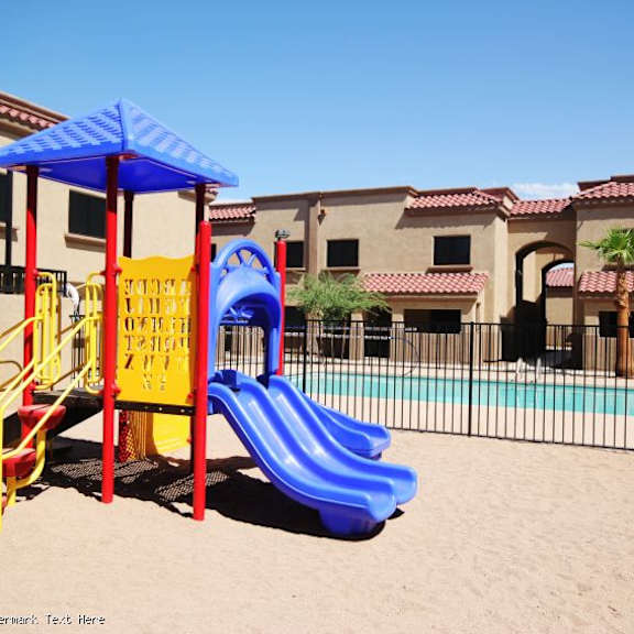 a playground with a blue slide and a yellow and red structure.