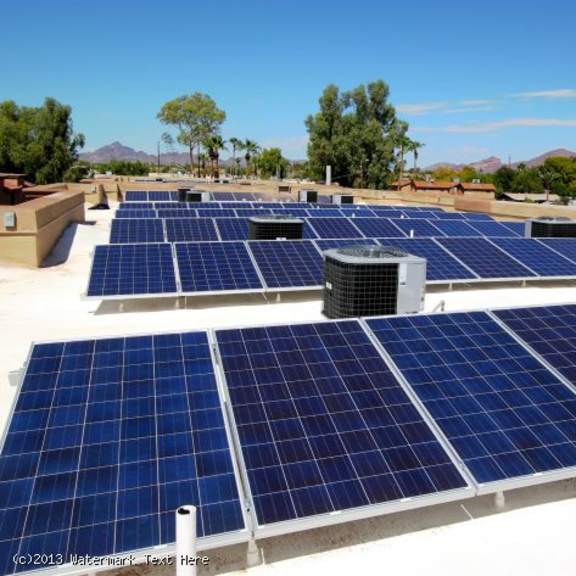 a large array of solar panels is installed on a rooftop.