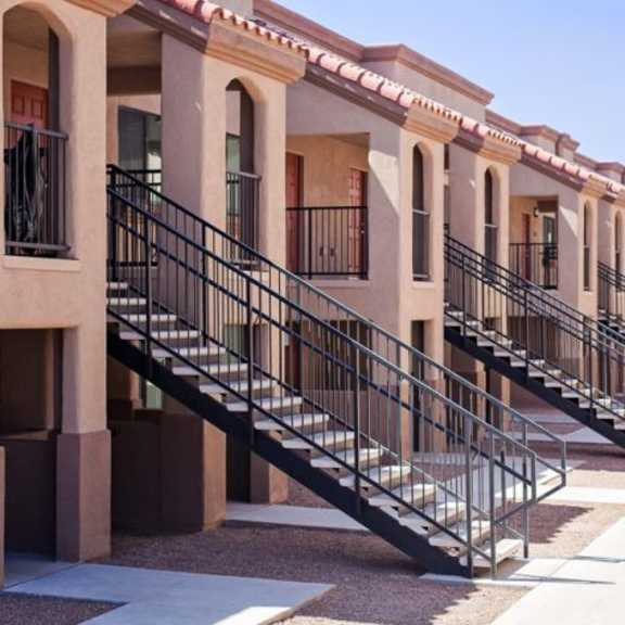 a series of terraced houses with black railings.