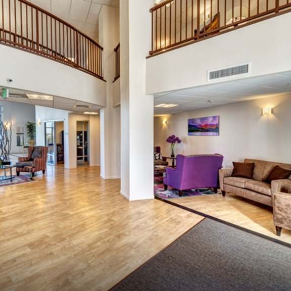 a living room with a purple couch and a fireplace.
