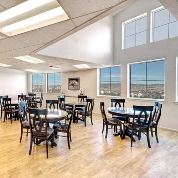 a room with a long table and chairs.