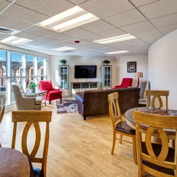 a living room with a wooden table and chairs.