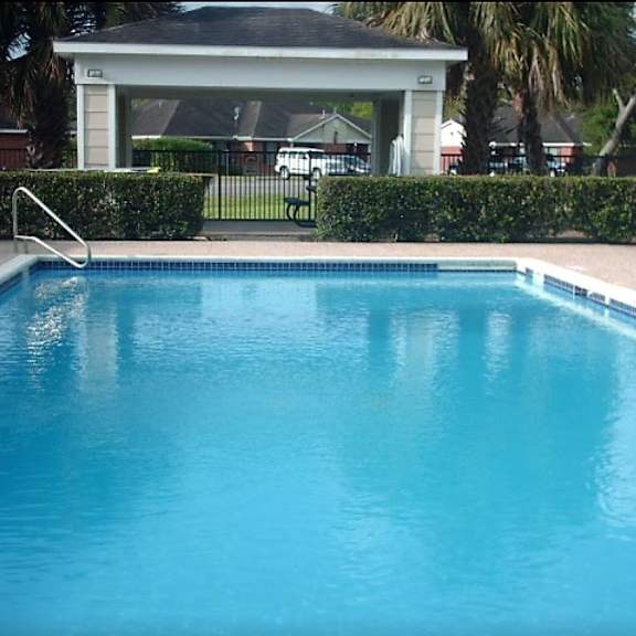 a small pool with a white fence around it.