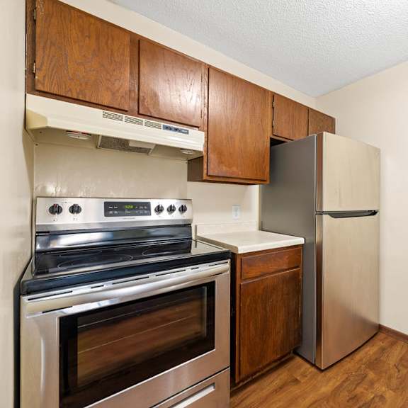 a kitchen with a stove, oven, and refrigerator.
