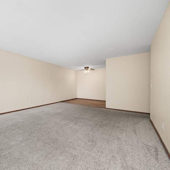 a large empty room with a carpeted floor and white walls.