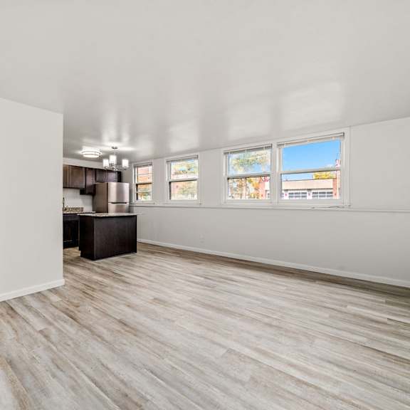 a room with a wooden door and a white wall.